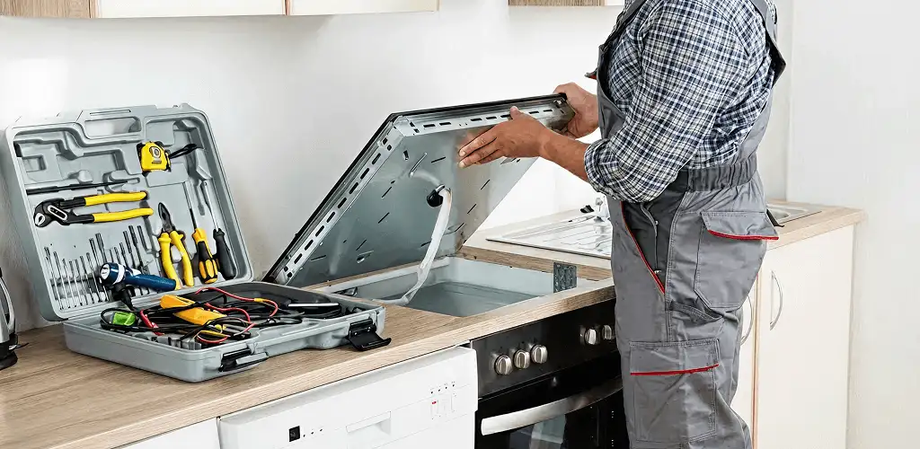 Handyman repairing a cooktop and checking wiring connections in Wilmington, NC