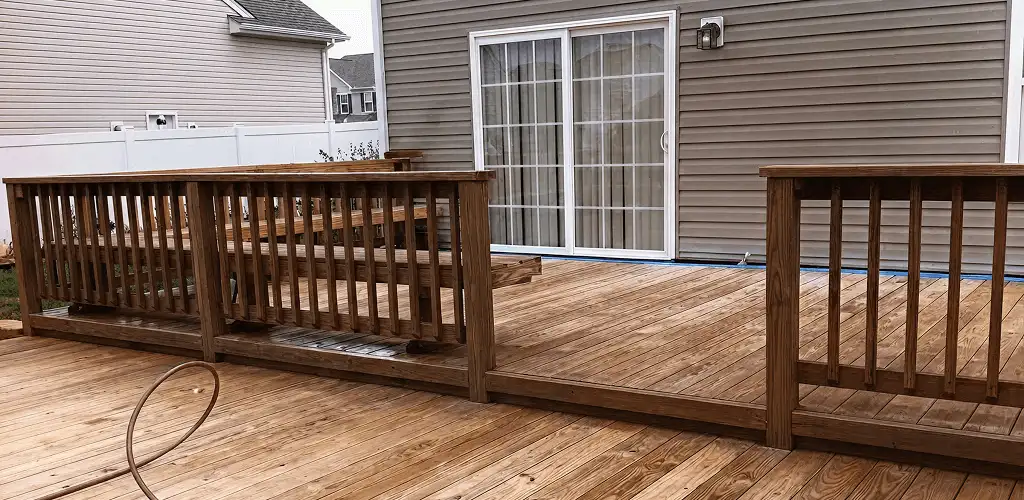 Deck sealing service protecting a backyard wood deck and railings in Wilmington, NC