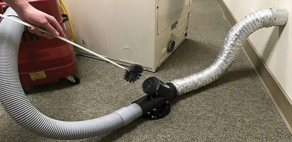 Dryer vent cleaning service removing lint from a dryer duct connection in Wilmington, NC