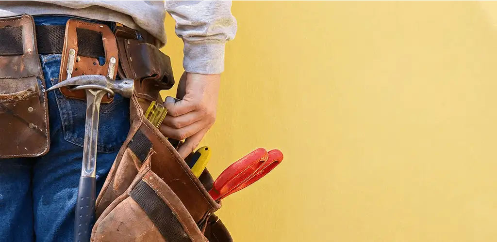 Handyman with tool belt ready for home repairs and maintenance in Wilmington, NC