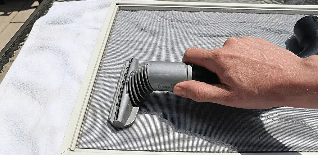 Window screen repair cleaning and fixing a damaged screen mesh in Wilmington, NC
